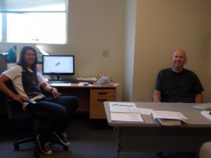 Two male students sitting in an office.